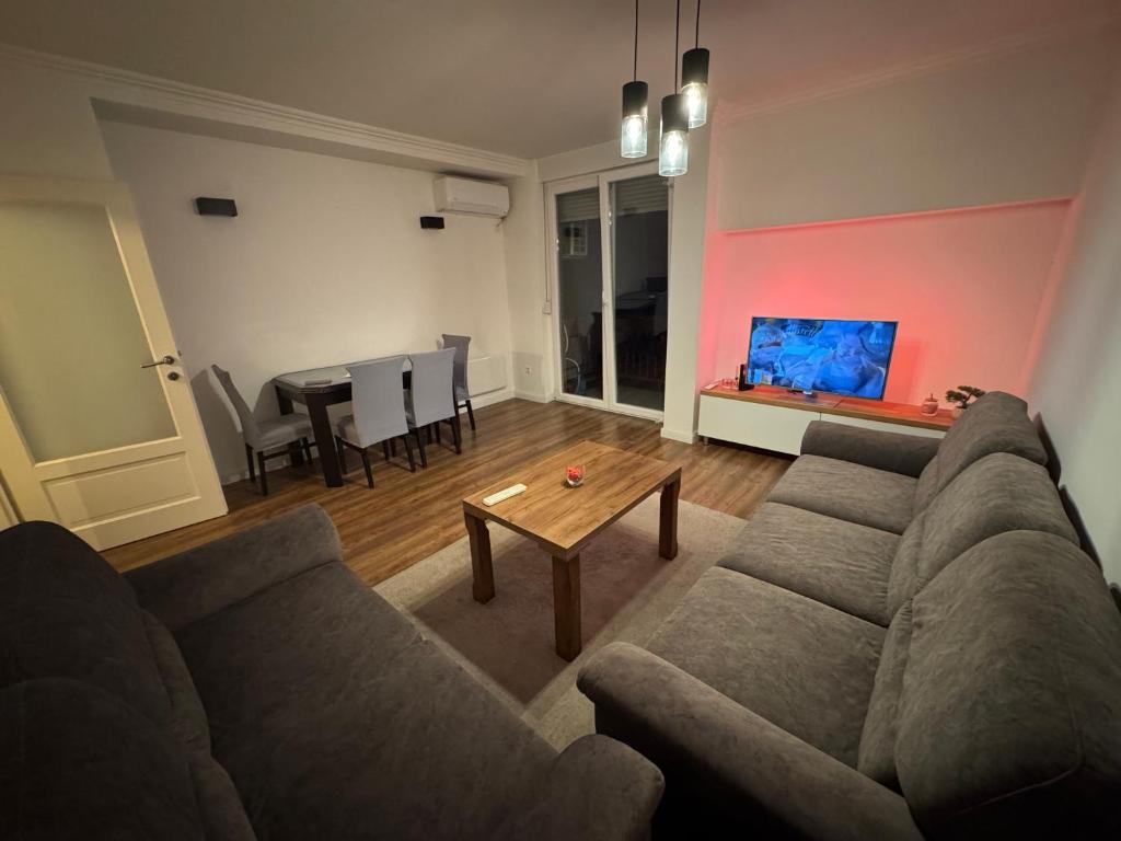a living room with a couch and a table at Apartman Novak Prijedor in Prijedor