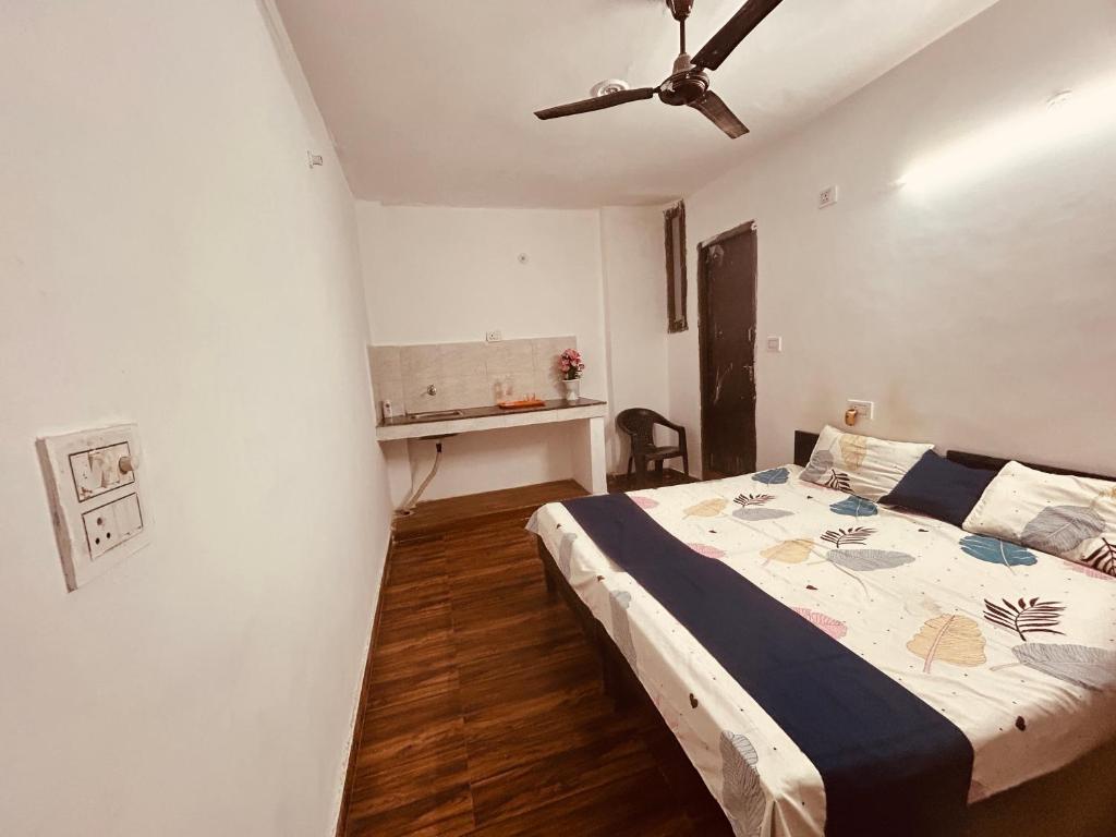a bedroom with a bed and a ceiling fan at BTS STAY- Singh Niwas in Ghaziabad