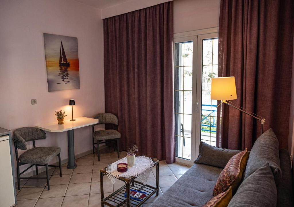 a living room with a couch and a table at Cretan Dawn Apart, Value Option in Ammoudara in Ayía Marína