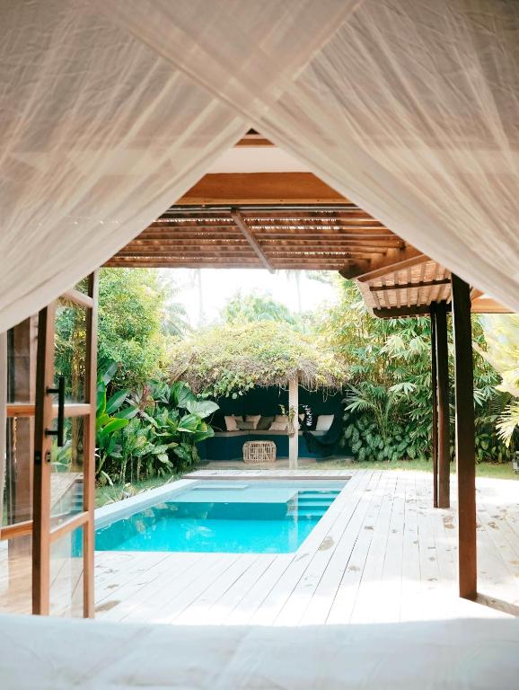 a pavilion with a swimming pool in a backyard at Marevka - Pool Villa with garden in General Luna