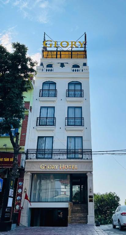 a white building with a sign on top of it at Glory Hotel Vĩnh Yên in Nhân Mỹ