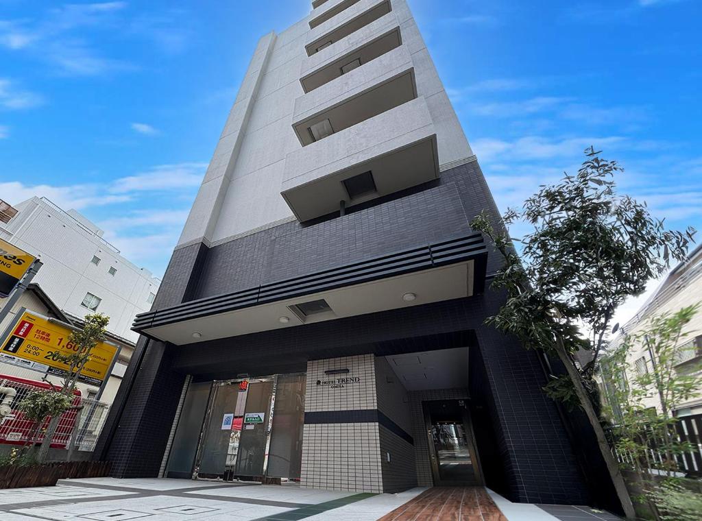 a tall building with a door in front of it at Hotel Trend Omiya in Saitama