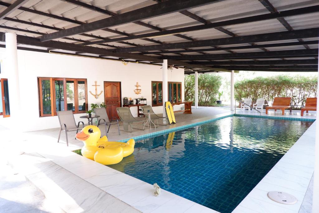 a pool with a rubber duck in the middle of a house at Pran Botanica Private Pool Villa in Ban Rom Pho