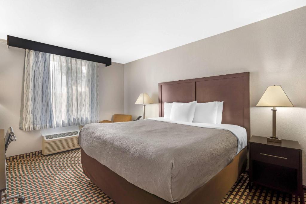 a hotel room with a large bed and a window at Quality Inn & Suites Chattanooga-East Ridge in Chattanooga