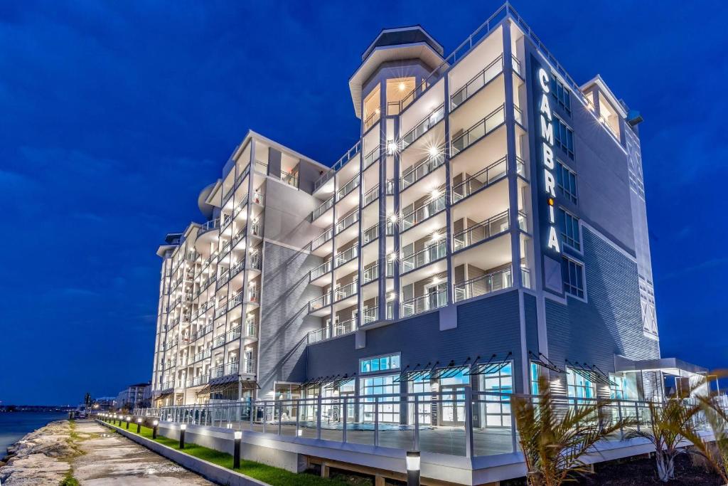 a large white building with a blue facade at Cambria Hotel Ocean City - Bayfront in Ocean City