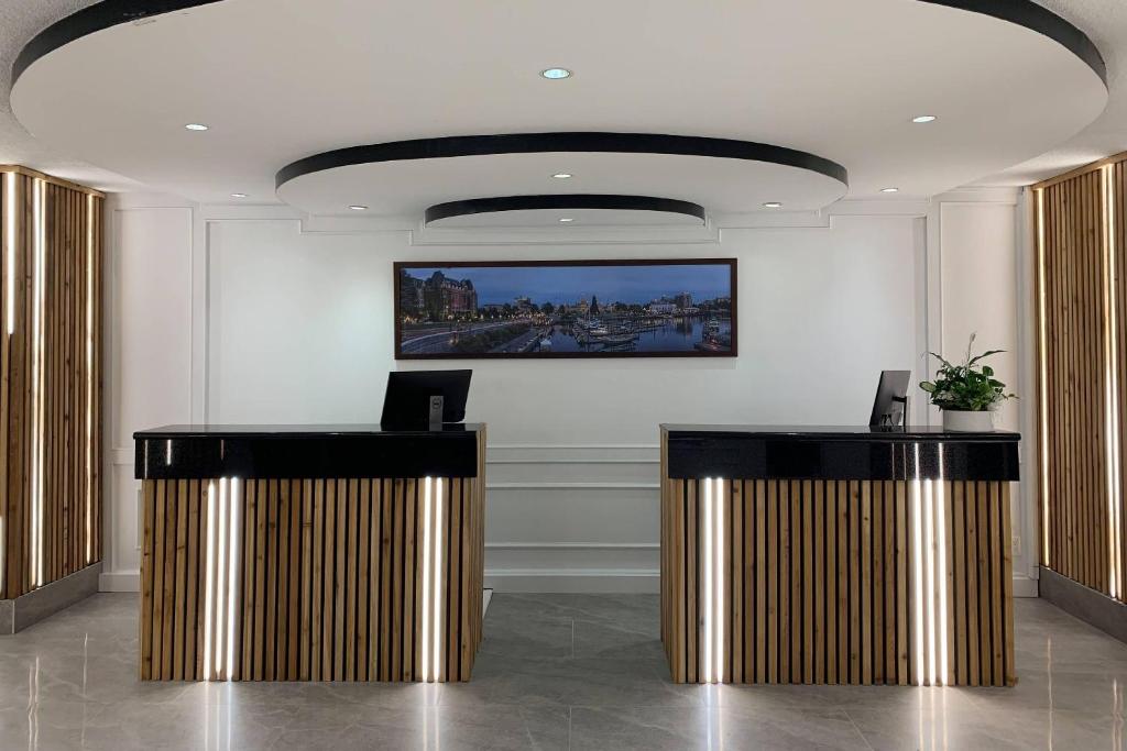 a lobby with two desks and a picture on the wall at The Vic, an Ascend Collection Hotel in Victoria