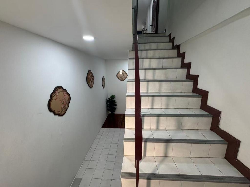 a staircase in a house with white walls at S Hostel Sukhumvit 48 in Bangkok