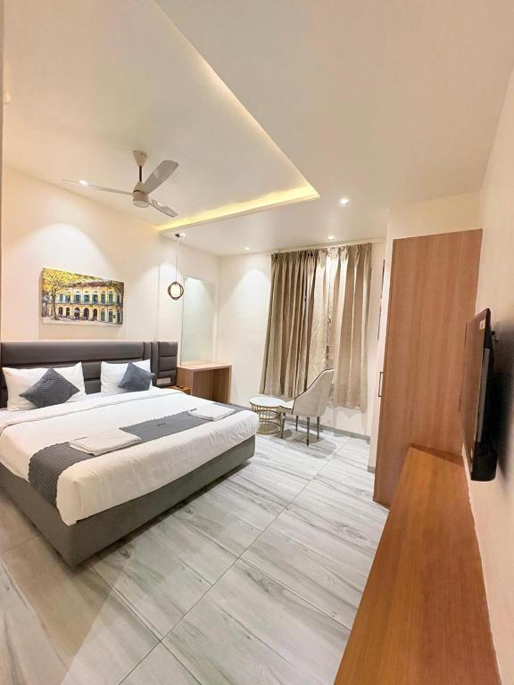 a bedroom with a bed and a desk and a tv at Hotel Moti Mahal in Ambikāpur