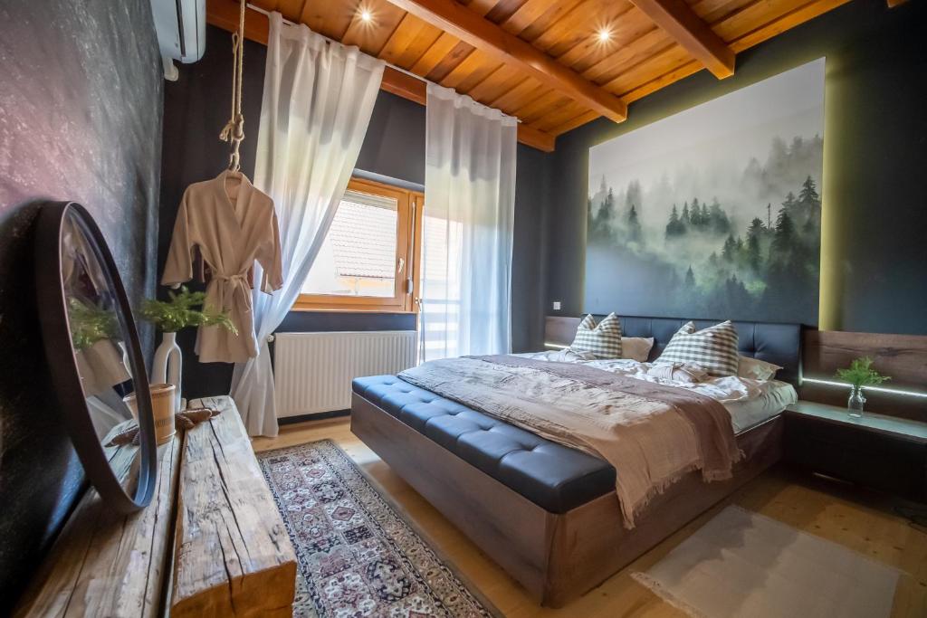 a bedroom with a bed and a large painting on the wall at FoxForest Vendégház in Zalakaros