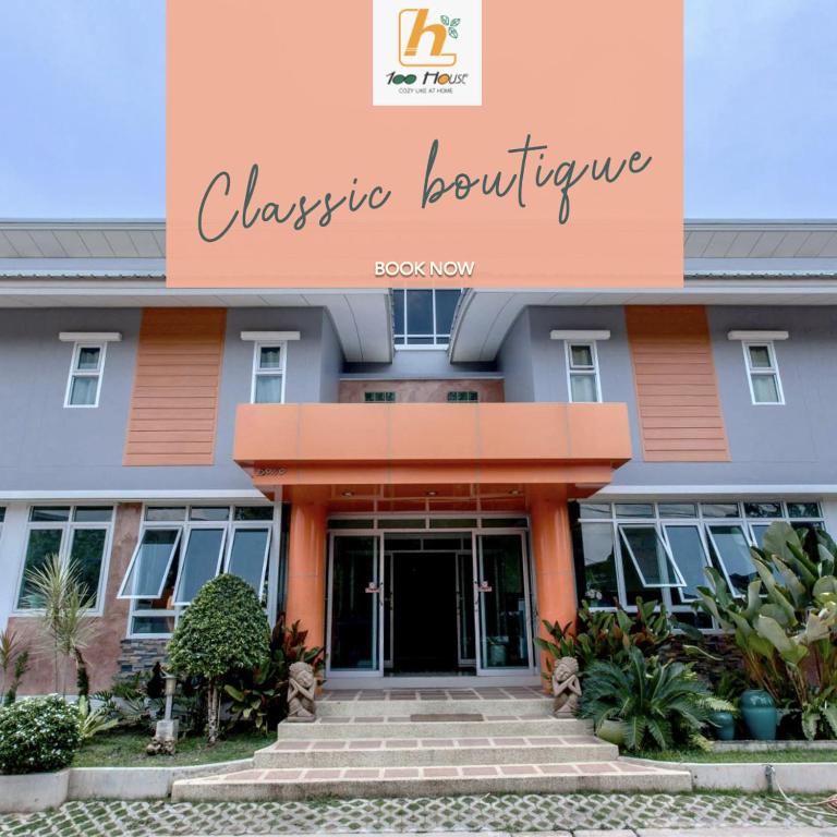 a building with a sign that reads classical architecture at 100House Hotel Korat in Ban Hua La Loeng