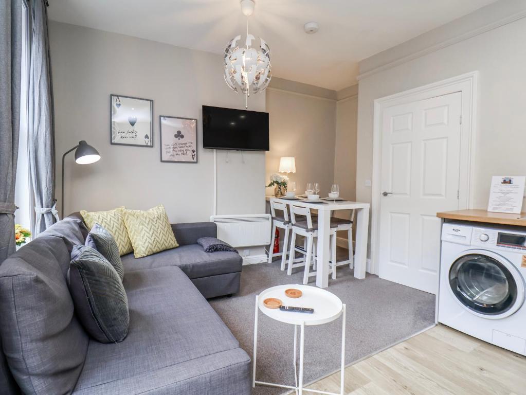 a living room with a couch and a table at Brinkleys Nook in Whitby