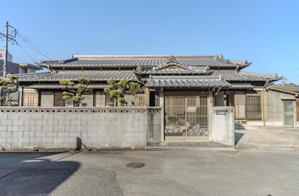 an old house with a gate in front of it at MITAMA House 01 ミタマ ハウス 01 in Ise