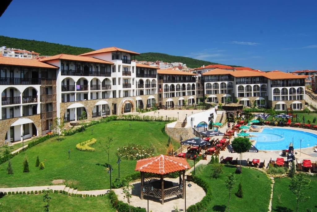 a resort with a large building and a swimming pool at Stylish, 1-Bedroom at Watermill Complex in Bŭnzareto