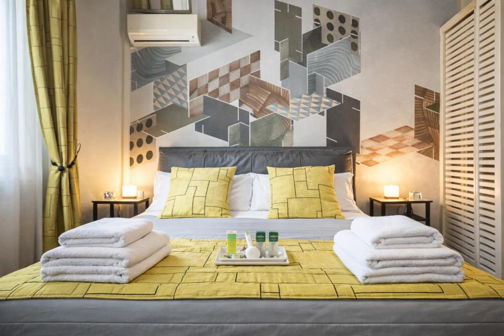 a bedroom with a bed with towels on it at Vittoria Residence Spanish Steps in Rome