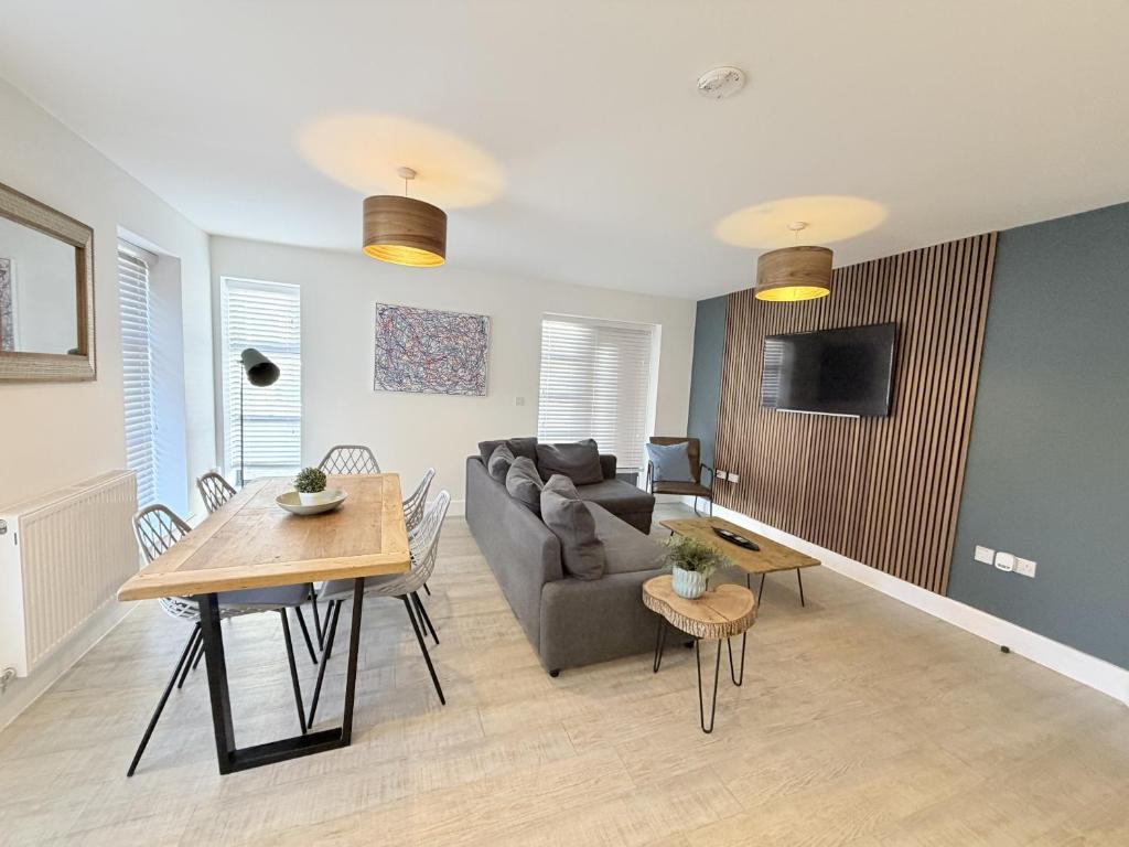a living room with a couch and a table at Orchard Point in Southampton