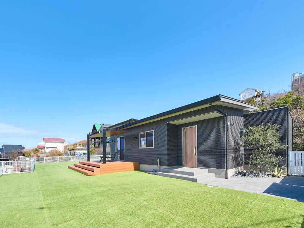 a small house with a yard with a lawn at HUG me Ocean awaji in Sumoto