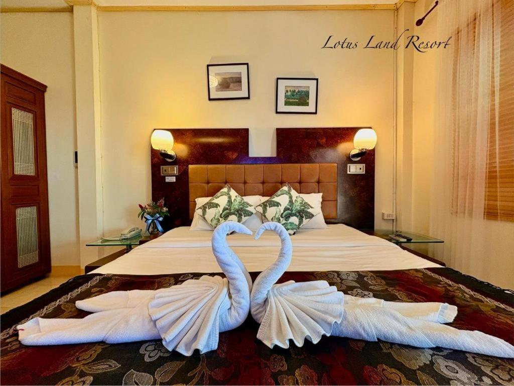 two swans making a heart shape on a bed at Lotusland Resort in Jomtien Beach