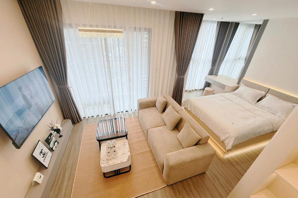 a living room with a large bed and a couch at Homestay Ocean Park Building P3 in Gia Lâm Pho