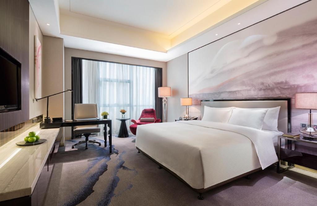 Letto o letti in una camera di Wanda Realm Wuhan
