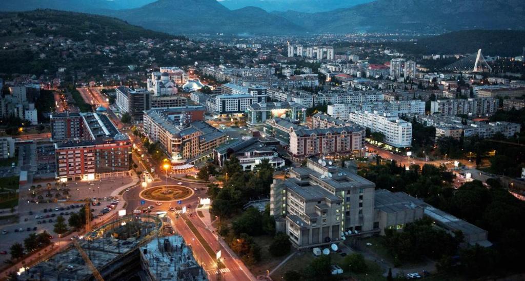 a city lit up at night with buildings at Apartment Temple in Podgorica