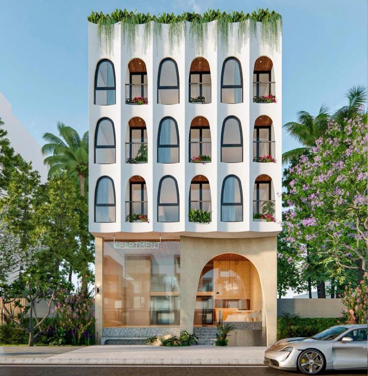 a building with windows and a car parked in front at Weal Apartment in Danang