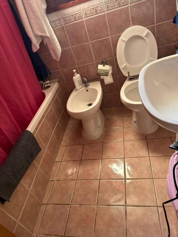 a bathroom with a toilet and a sink at HermanHouse in Bacoli