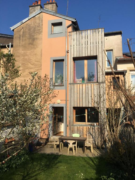 a house with a picnic table in front of it at Maison Nancy Thermal in Nancy