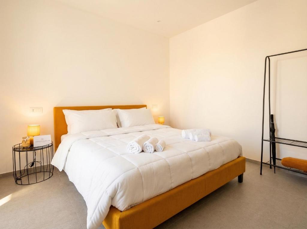 a bedroom with a bed with two towels on it at Dimora dei Colori - Yellow Light in Bari