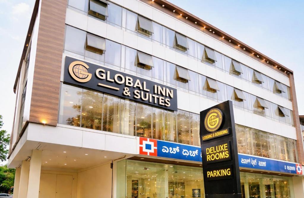 a building with a sign for a global inn and suites at Global Inn & Suites in Mangalore