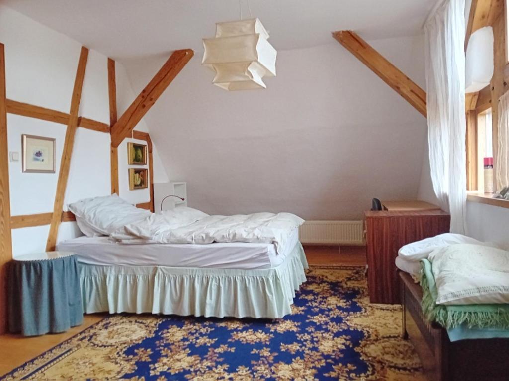 a bedroom with two beds and a rug at Gemütliche Ferienwohnung in Ranstadt in Ranstadt