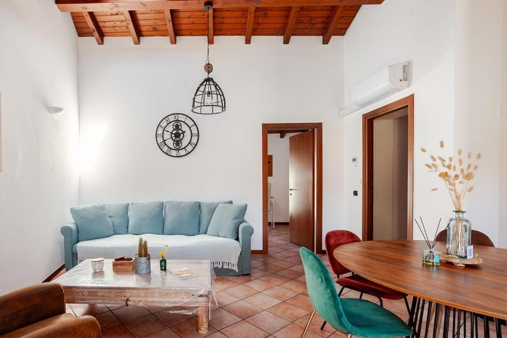 a living room with a blue couch and a table at Like Home XX Settembre in Sesto Calende