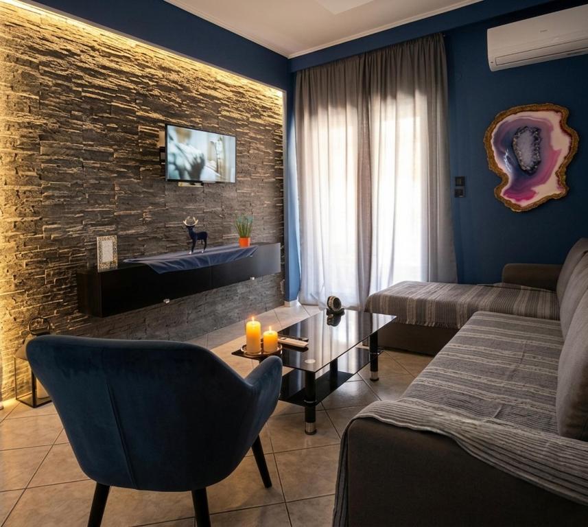 a living room with a bed and a couch at Maka's Design Suite-Trikala in Tríkala