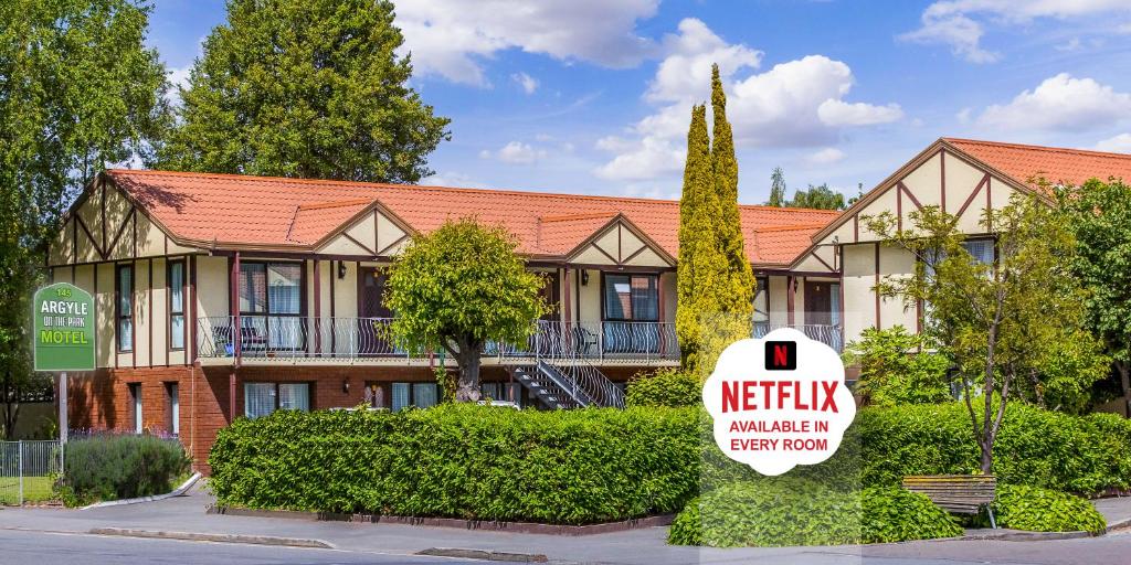 a hotel with a sign in front of a building at Argyle On The Park - Central Christchurch Motel Overlooking Hagley Park in Christchurch
