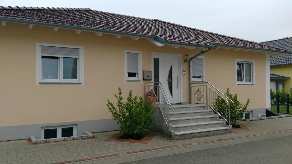 a house with a staircase leading to the front door at Ferienwohnung Keil in Lahr