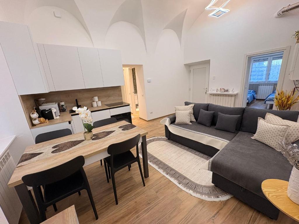 a living room with a couch and a table at Home Albert-Lago Maggiore Luino in Luino