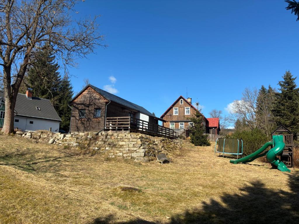 a playground in front of a building with a house at Bedřichov Jaroš in Bedřichov
