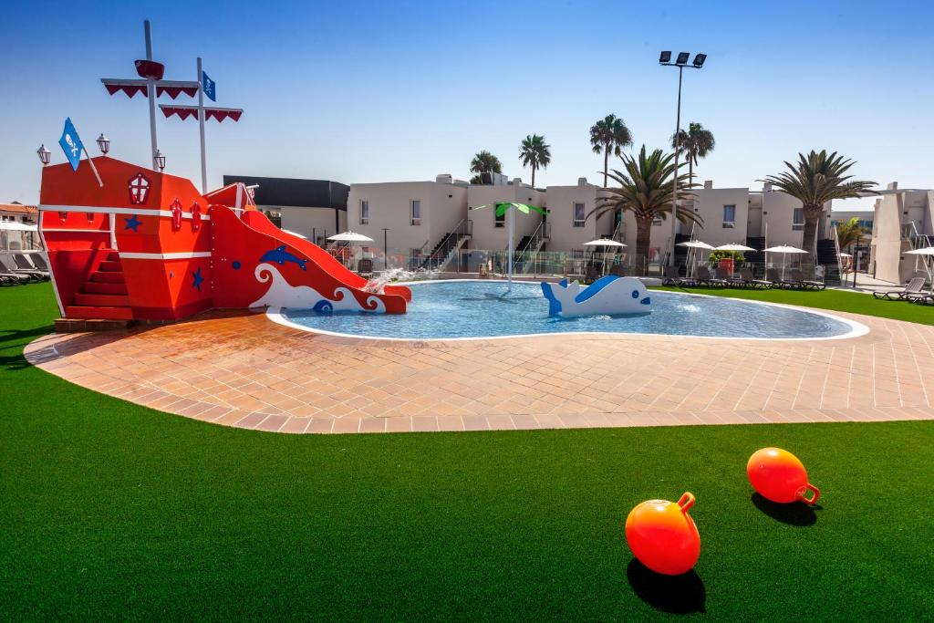 a pool with a water park with a water slide at Barceló Corralejo Sands in Corralejo