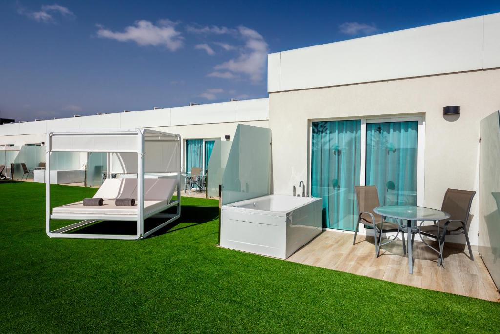a rendering of a house with a green lawn at Barceló Corralejo Sands in Corralejo