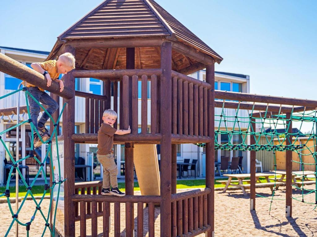 a man and a boy playing on a playground at Blokhus Feriecenter in Blokhus