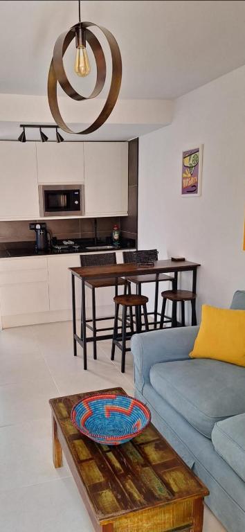 a living room with a blue couch and a table at CASA LUKASA 39c in Costa Calma