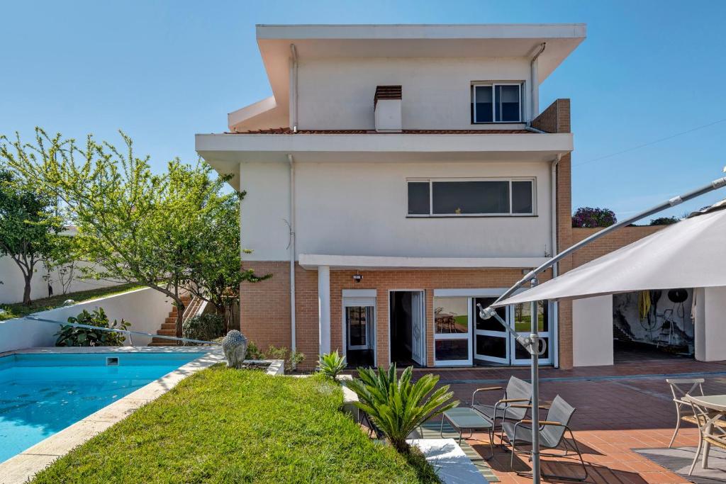 a villa with a swimming pool and a house at Archer'shouse - Olival's Treasure in Olival