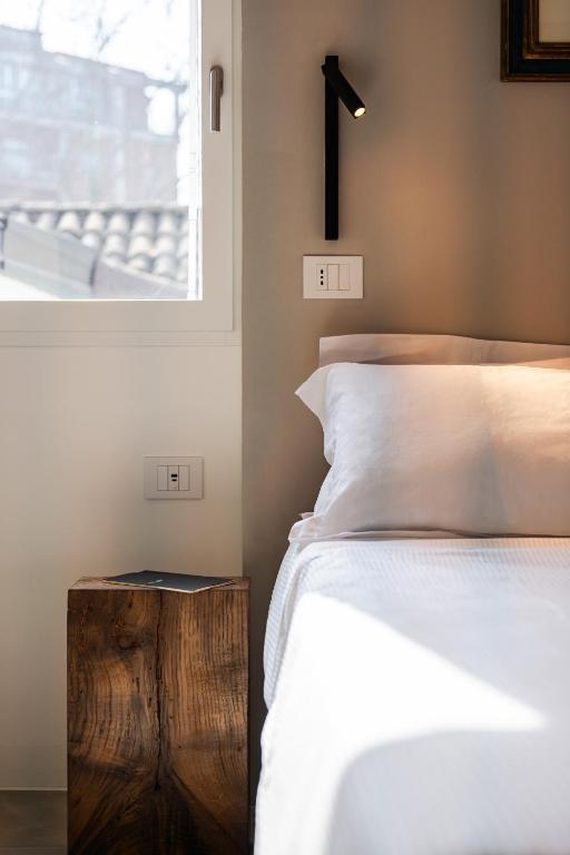 a bedroom with a bed and a cross on the wall at Margherita Home in Reggio Emilia
