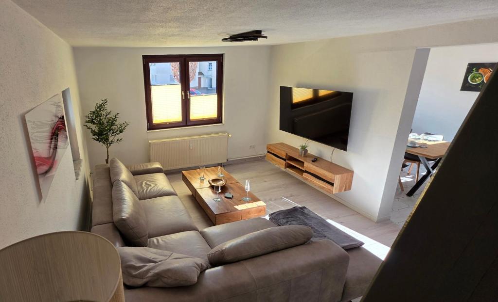 a living room with a couch and a television at Apartment Me-Time in Bad Salzungen