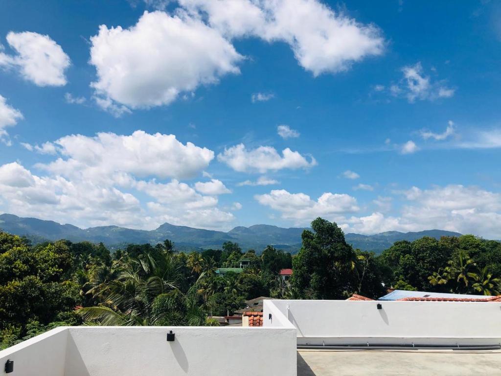 a view of the mountains from the roof of a house at Ruk Mountain Hotel in Kengalla