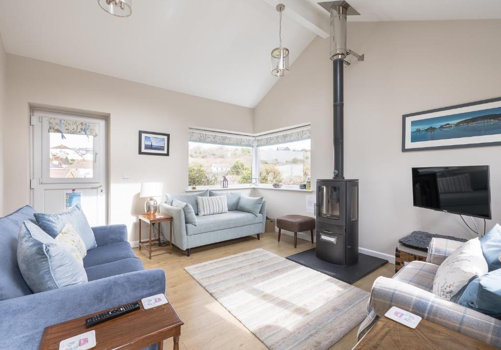 a living room with a couch and a fireplace at Highview, extended 2 bedroom house, with view, near coast path in The Mumbles