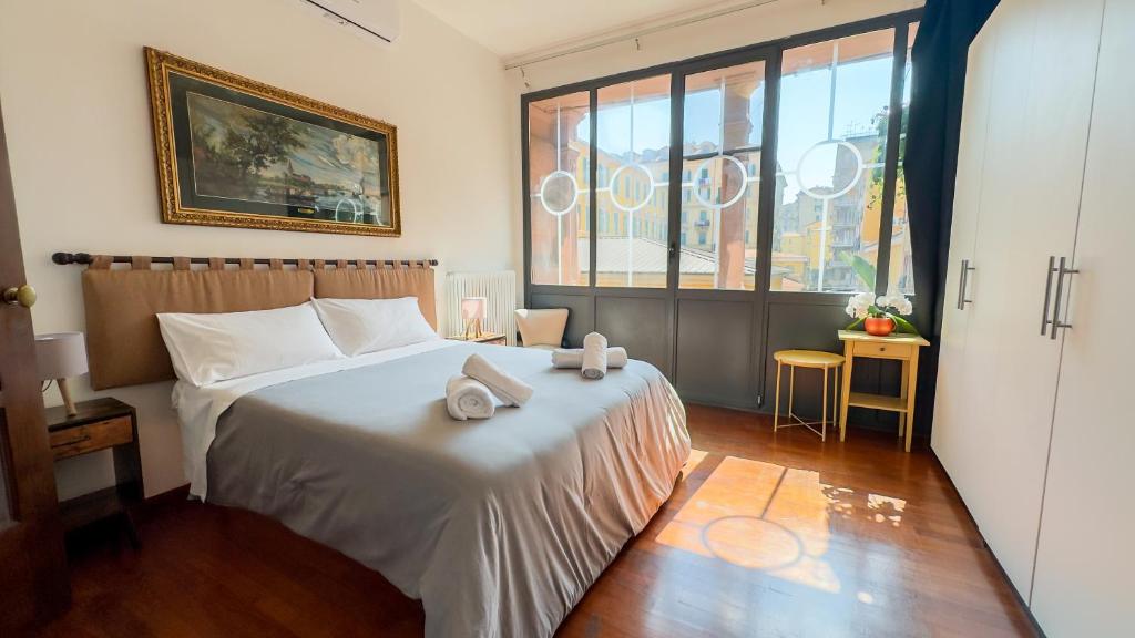 a bedroom with a bed with two towels on it at Veranda Liberty, luxury apartment in La Spezia
