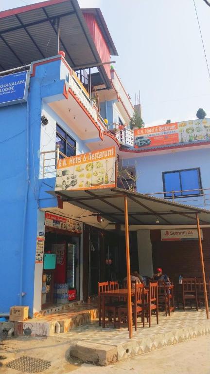 a blue building with tables and chairs in front of it at B N Hotel & Restaurant in Rāmechhāp