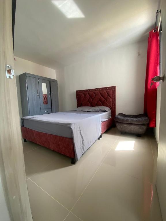 a bedroom with a bed and a chair in it at casa trieste in Jamundí