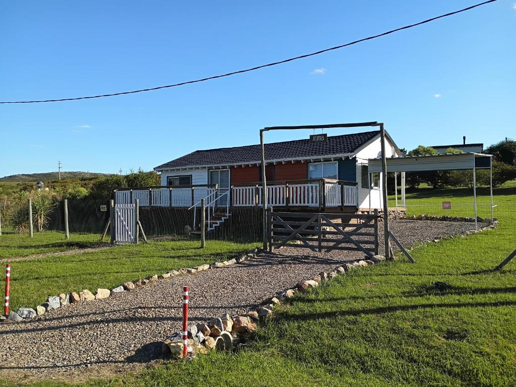a house with a playground with sheep in the grass at Runa, Marcos de los Reyes villa serrana in Minas