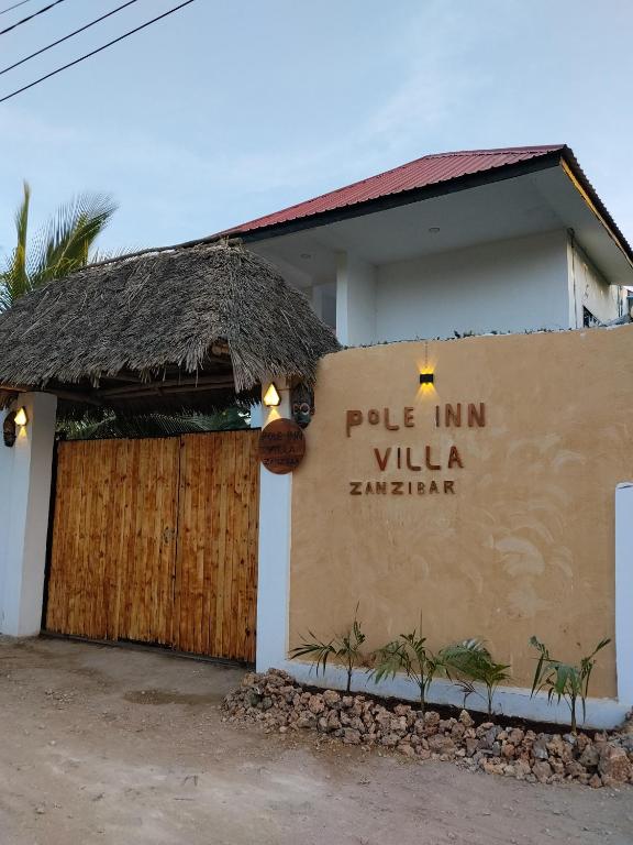 a sign for a pub in villa hennie at POLE-INN VILLA Nungwi Zanzibar in Nungwi